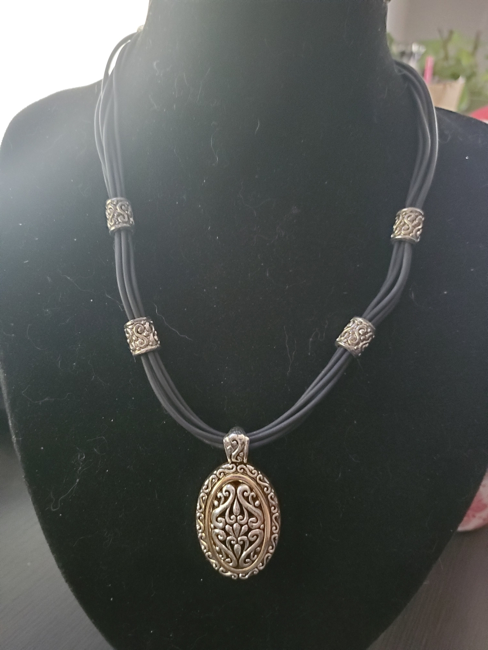 Black Multi-Strand Cord Necklace with Ornate Silver-Tone Oval Pendant